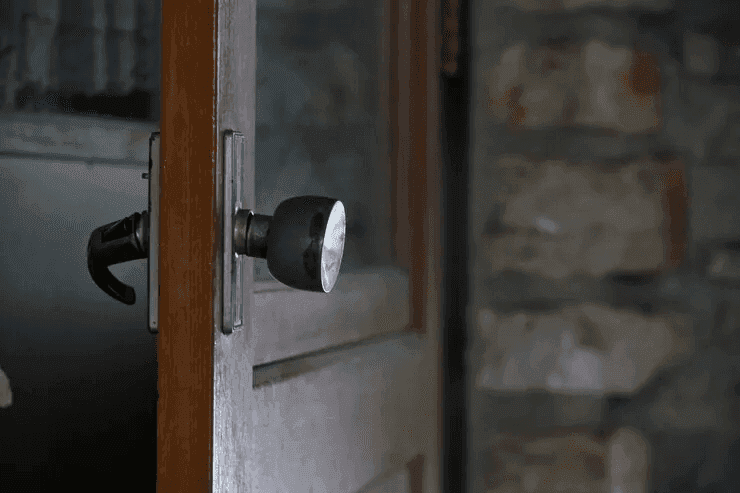 Close-up of a wood front door lock and handle, the type of residential entry door we open during a home lockout