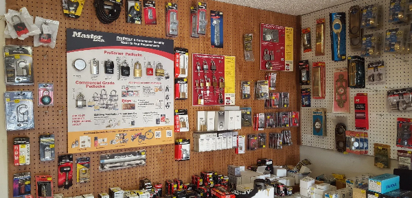 Wall display of commercial-grade padlocks and security hardware stocked inside Bill's Locksmith Service shop in Marble Falls, TX